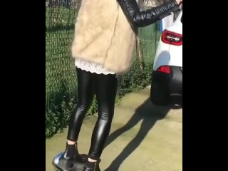 girl in leggings on an electric scooter